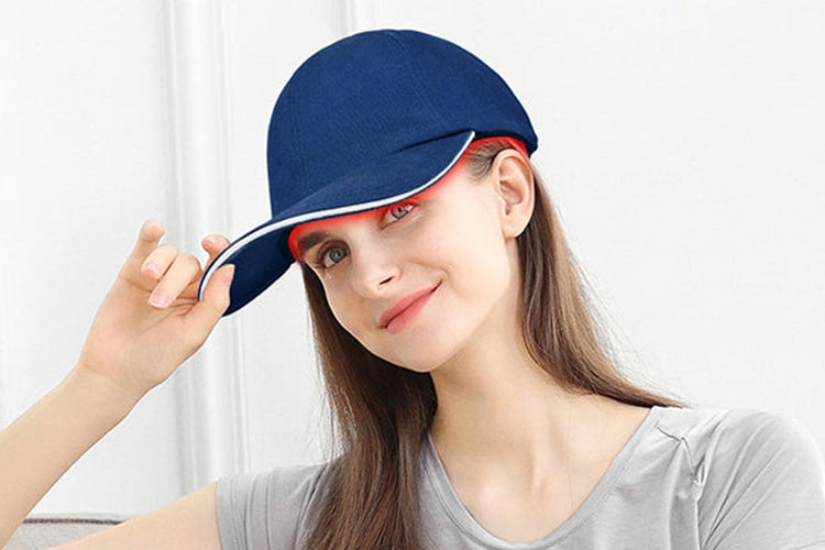 Woman wearing red light therapy cap for hair growth treatment