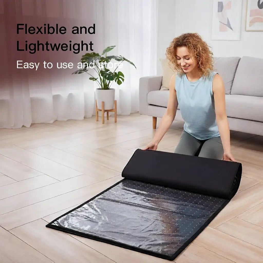 Woman rolling out a flexible, lightweight red light therapy mat in a living room, easy to use and store