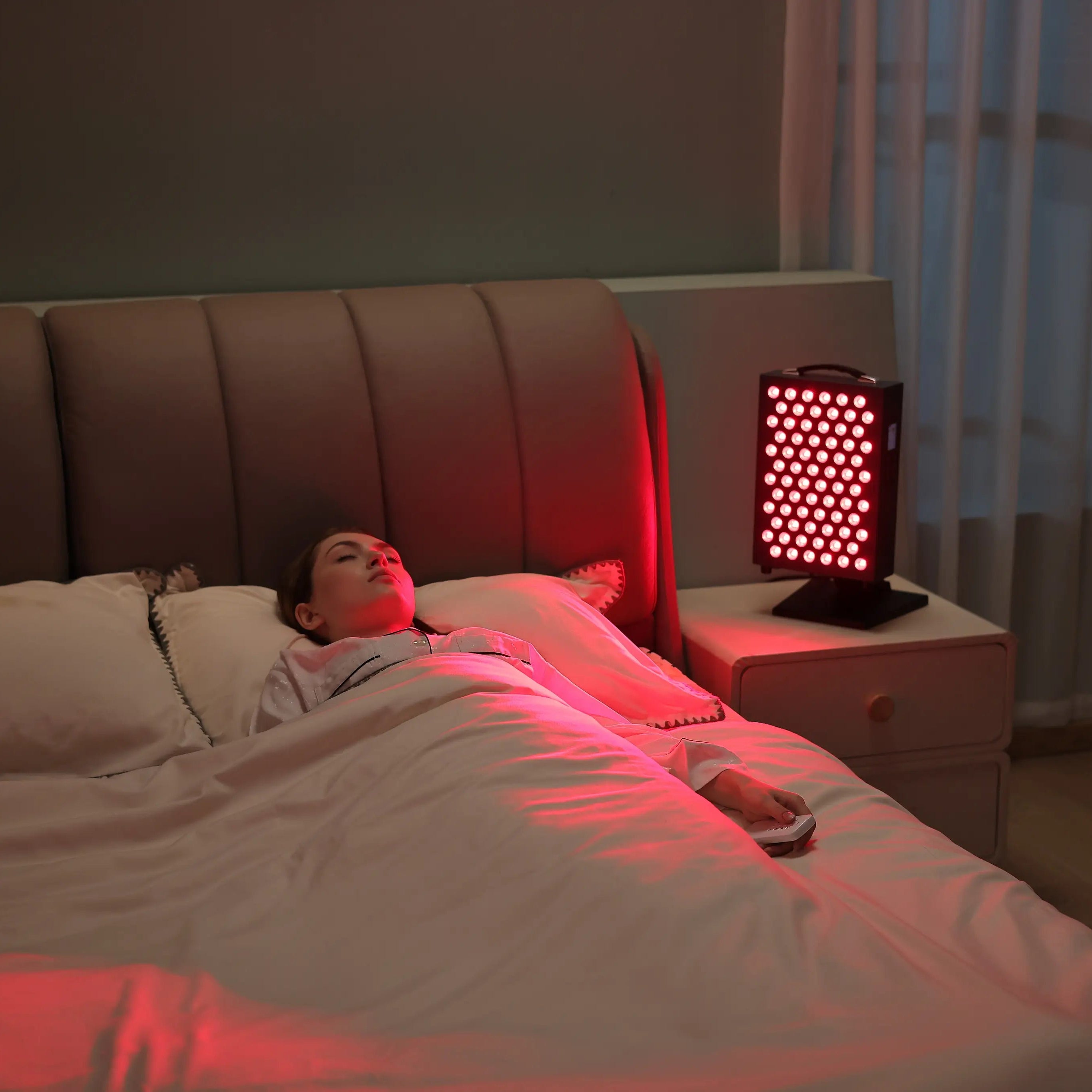 Bedside red light therapy session at home with YouLumi desktop panel on nightstand