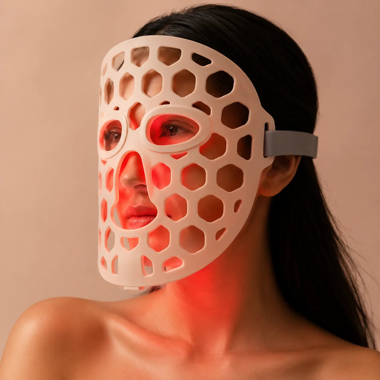 LED light therapy face mask with red glow for at-home skincare treatment