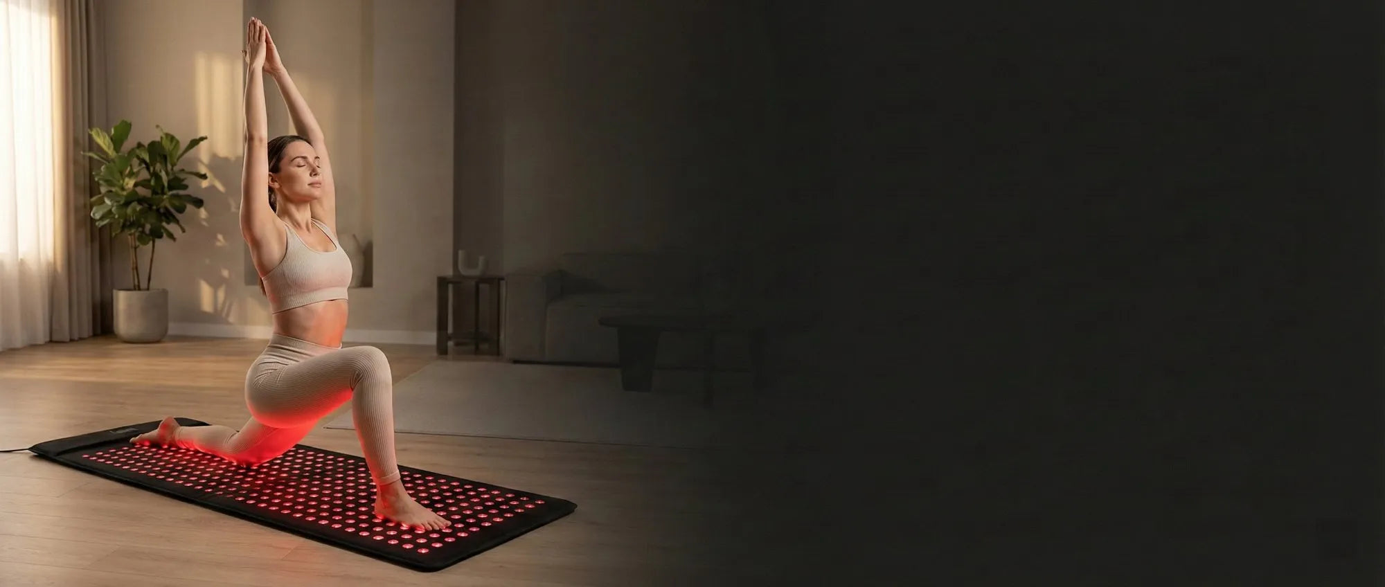 Woman stretching on Youlumi red light therapy mat in a modern living room, enjoying a relaxing wellness session
